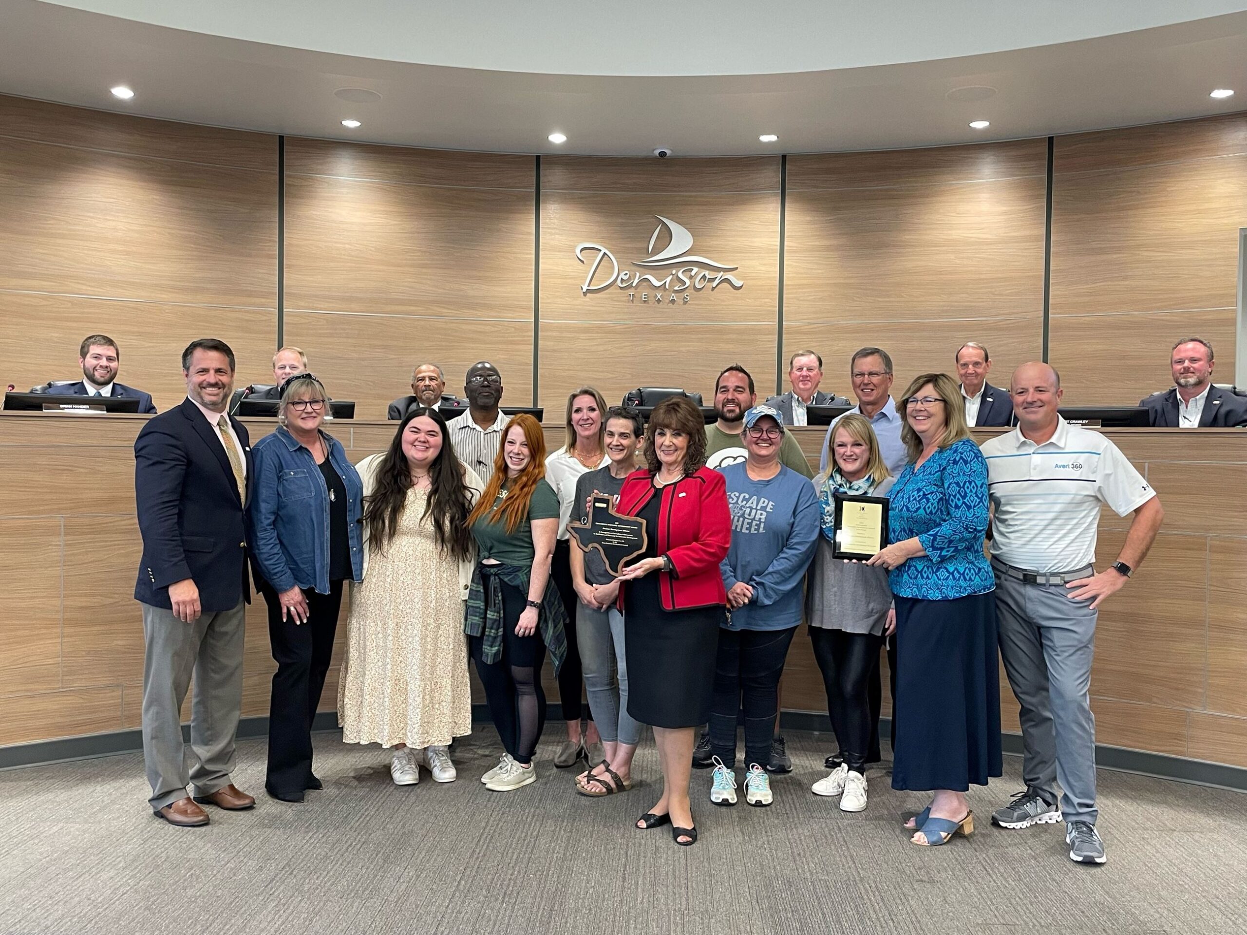 Standing left to right: Denison leaders recognized the local participants in the award-winning Ecommerce Accelerator Incentive program Monday night at the City Council meeting. Present to represent the program were: William Myers, DDA; Elsie Russell, 2 Chicks Home and Market; Jenna Zapata, Zig Zag Galleries; Neal Spencer, Spiffy Spa; Natalie Popplewell, 410 Collective + Coffee; Cathy Cobb, Totally Addicted; Nitia Musico, Monsters on Main; Denison Mayor Janet Gott; Derrick Roberts, Pop Around the Corner; Kimberlea Donohoe-Miller, The Hangin T; Wendy Acosta, The Desk and Easel; Tony Kaai, DDA; Donna Dow, Denison Main Street; and Michael McKinley, Avert 360. Seated left to right, Council members: Brian Hander, Dr. Michael Courtright, Robert Thorne, J.C. Doty, Robert Crawley and Kristofer Spiegel.